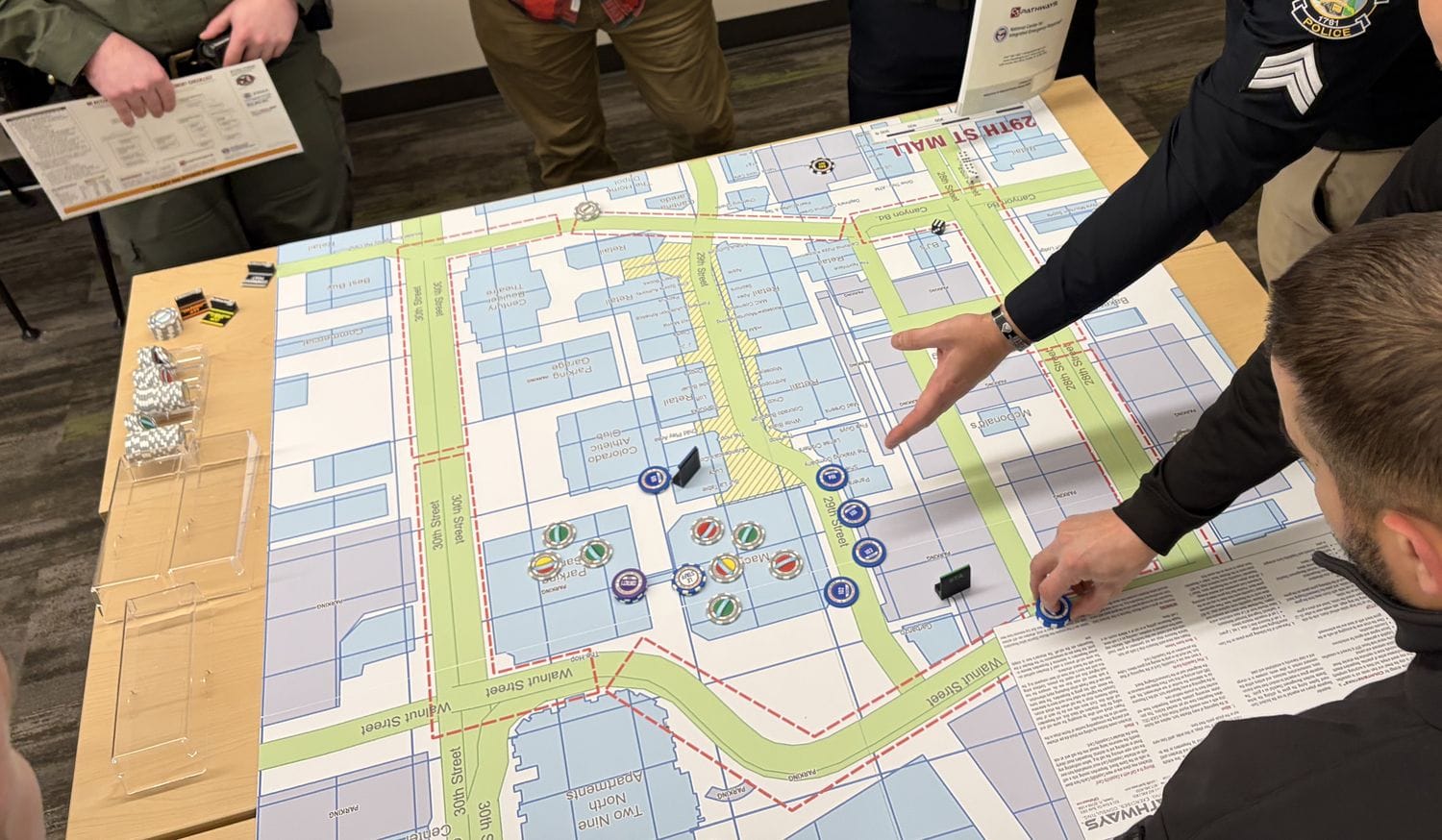 A team working a printed Counterstrike environment map during a scenario